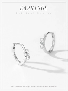 Macro detail of S925 sterling silver bow earrings featuring sparkling cubic zirconia