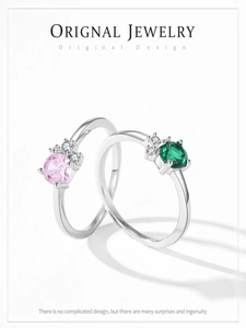 Detail of S925 silver rings with emerald green and pink zircon stones in minimalist design