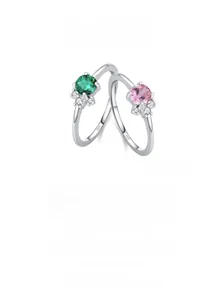 Macro shot of S925 sterling silver rings with emerald and pink stones showing S925 hallmark