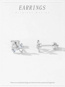 Detailed view of S925 silver bow earrings with pear-cut cubic zirconia and 925 hallmark