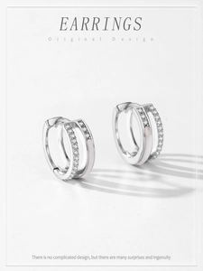 Close-up of S925 silver double-layer Mobius earrings with cubic zirconia and white enamel