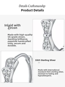 Detailed close-up of S925 sterling silver bow earrings with hand-set AAA zircons