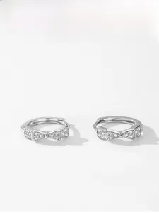 Close-up of S925 sterling silver bow earrings with sparkling pave-set cubic zirconia