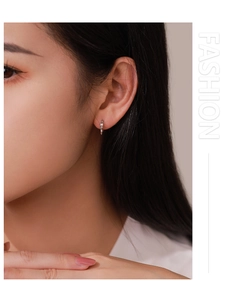 Detailed view of elegant S925 silver bow-shaped hoop earrings on a female model