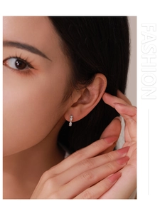 Close-up of elegant S925 silver bow earrings with sparkling pavé zircons on model