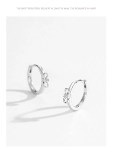 Macro detail of S925 sterling silver bow earrings with sparkling micro-inlaid cubic zirconia