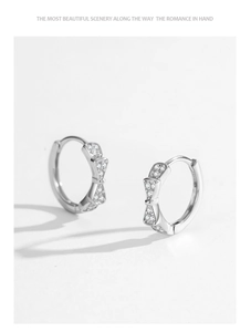 Close-up of S925 sterling silver bow earrings featuring micro-paved sparkling cubic zirconia