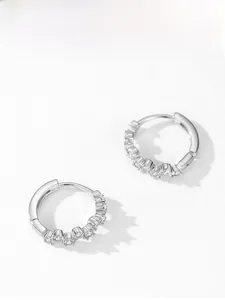Macro shot of S925 sterling silver hoop earrings with sparkling cubic zirconia settings