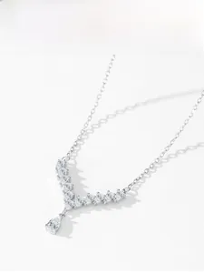Detail of S925 sterling silver V-shape necklace with teardrop pendant and sparkling stones