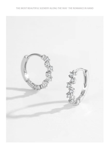 Macro shot of S925 sterling silver hoop earrings with sparkling inset zircon stones