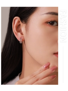 Close-up of S925 sterling silver double Mobius hoop earrings with paved cubic zirconia