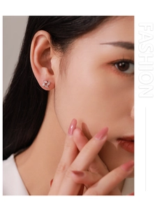 Close-up of S925 silver windmill stud earrings with sparkling marquise cubic zirconia