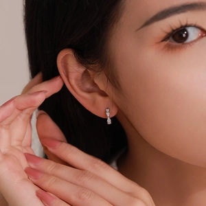 Elegant S925 sterling silver bow earrings with micro-pave crystals on female model