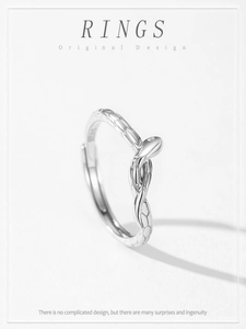 Macro detail of silver snake ring featuring intricate scale textures and elegant head design