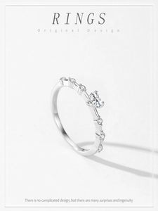 Close-up of heart-cut diamond 925 silver ring with small stones and high-polish finish