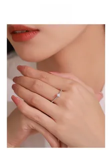 Sparkling S925 sterling silver ring with round solitaire diamond shown on model's finger