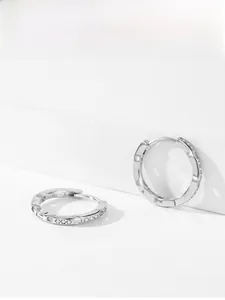 Detail of silver S925 sterling silver hoop earrings with micro-set cubic zirconia stones