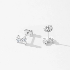 S925 sterling silver bow stud earrings with sparkling cubic zirconia on white background