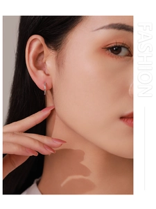 Close-up of S925 sterling silver hoop earrings with pavé zircon stones on a model