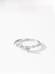 Macro detail of 925 sterling silver ring featuring a sparkling heart shaped center stone