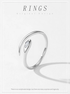 Macro shot of 925 silver snake ring featuring marquise-cut zircon on white paper texture