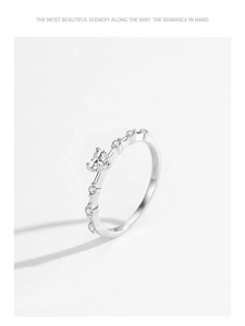 Close-up of sparkling heart-shaped diamond ring with pavé stones in 925 silver finish