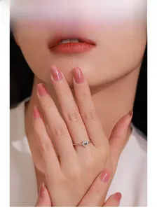 Close-up of a model wearing a S925 sterling silver hollow heart ring with cubic zirconia