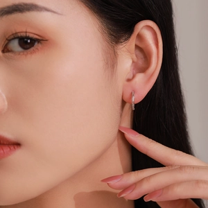 Minimalist S925 sterling silver hoop earrings with interlocking G pattern worn by model