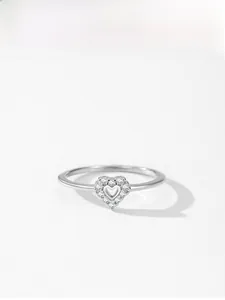 Macro detail of S925 sterling silver heart ring with pavé-set zircons and hollow center