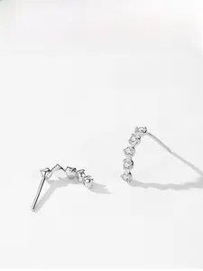 Close-up of elegant S925 sterling silver curved earrings with sparkling cubic zirconia