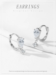 Detailed view of S925 silver hallmark and pear-cut cubic zirconia on luxury drop earrings