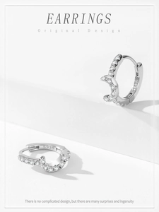 Close-up of S925 sterling silver hoop earrings with moon charm and pavé cubic zirconia