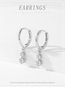 Macro view of S925 sterling silver hoop earrings with sparkling double cubic zirconia charms