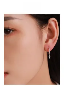 Close-up of model wearing S925 sterling silver geometric rhombus hoop earrings with zircon