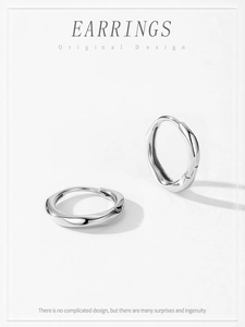 Detailed close-up of S925 sterling silver hoop earrings with a twisted Mobius design