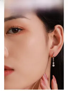 Close-up of a 925 sterling silver hoop earring with shimmering cubic zirconia pendants