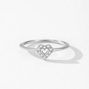 Elegant S925 sterling silver hollow heart ring with sparkling zircons on white background