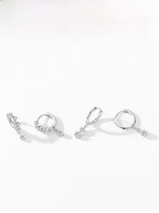 Macro detail of 925 sterling silver hoop earrings with sparkling zircon pendant display