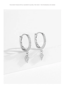 Macro detail of S925 sterling silver geometric rhombus hoop earrings with zircon