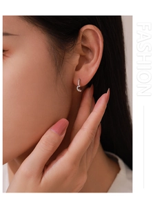 Close-up of S925 sterling silver heart-shaped earrings with pave-set cubic zirconia