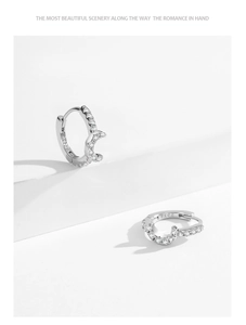 Macro detail of S925 sterling silver crescent moon earrings with cubic zirconia inlay