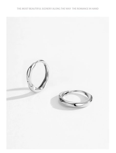 Macro shot of twisted S925 sterling silver hoop earrings with a liquid metal texture