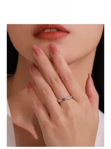 Model wearing a minimalist S925 silver hollow heart and infinity ring with zircons