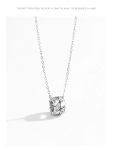 Detail showing S925 sterling silver cylinder pendant with geometric patterns and crystals