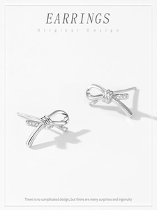 Macro detail of S925 sterling silver bow earrings with sparkling pavé cubic zirconia