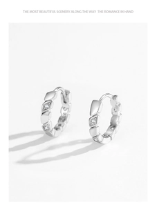 Detailed view of geometric 925 sterling silver hoop earrings with inset zircon stones