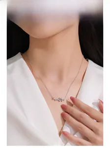 Close-up of 925 sterling silver necklace with sparkling star charms on a female neck