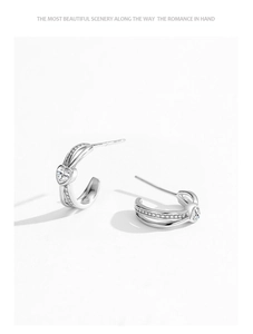 Detail of S925 sterling silver heart stud earrings with cubic zirconia and C-shape design