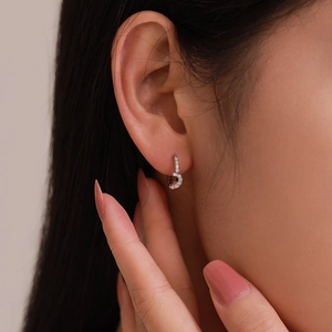 Elegant S925 sterling silver star hoop earrings with sparkling cubic zirconia on a model