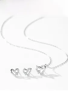 Detailed product display of S925 silver hollow heart necklace and stud earrings set